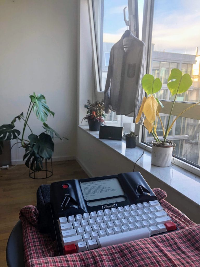 nick ang writing on his astrohaus freewrite at home