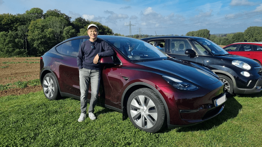 34 year old me with my own Tesla Model Y at an apple farm in Germany