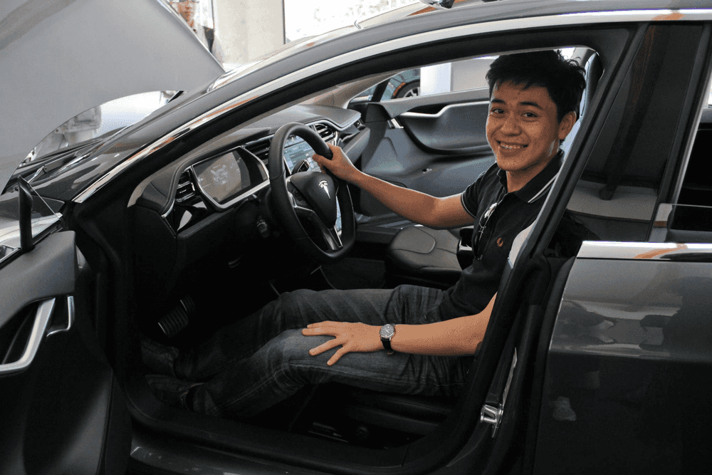 23 year old me inside a Tesla Roadster in San Jose